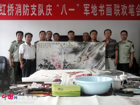 天津红桥消防支队举办庆“八一”军地书画联谊笔会消防官兵在“前程似锦”画作前留念
